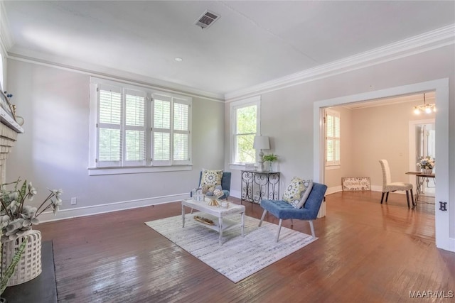 sitting room featuring crown molding, baseboards, wood finished floors, and a chandelier