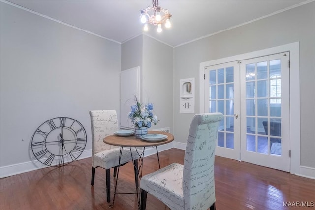 dining room featuring french doors, crown molding, wood finished floors, a chandelier, and baseboards