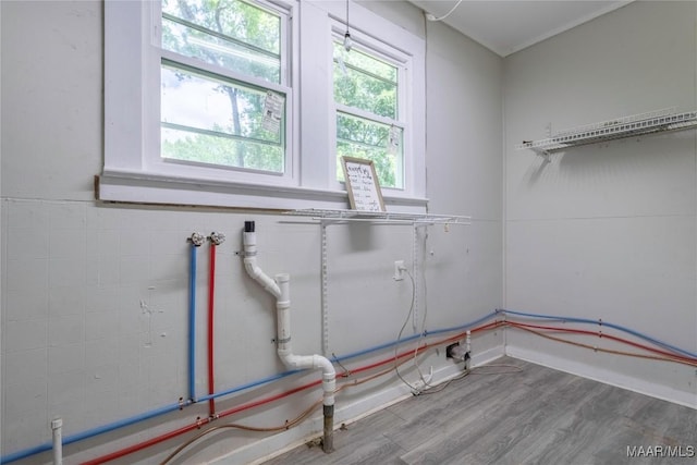 clothes washing area featuring wood finished floors