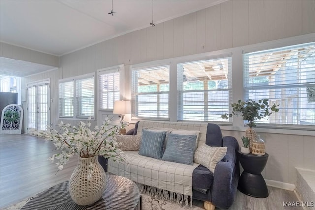 living room with crown molding, healthy amount of natural light, and wood finished floors