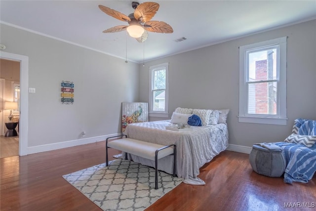 bedroom with ornamental molding, baseboards, wood finished floors, and ceiling fan