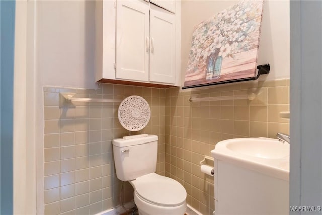 bathroom featuring tile walls, toilet, and vanity