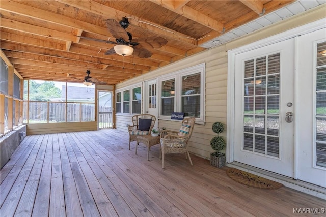 sunroom featuring ceiling fan, plenty of natural light, and beam ceiling