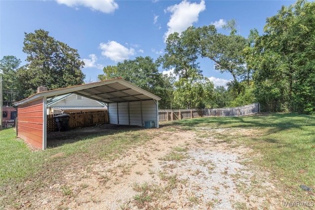 view of yard featuring driveway and a detached carport