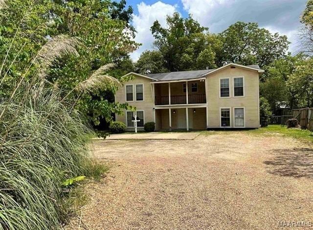 4097 Narrow Lane Rd, Montgomery, AL 36111 - back of house with a balcony, fence, and view of scattered trees