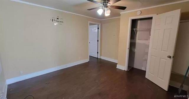 4097 Narrow Lane Rd, Montgomery, AL 36111 - unfurnished bedroom featuring crown molding, baseboards, dark wood-style flooring, and a ceiling fan