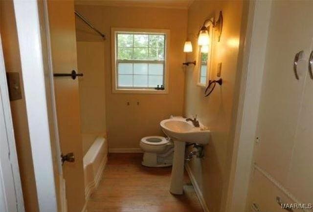 4097 Narrow Lane Rd, Montgomery, AL 36111 - full bath featuring toilet, wood finished floors, baseboards, tub / shower combination, and a sink