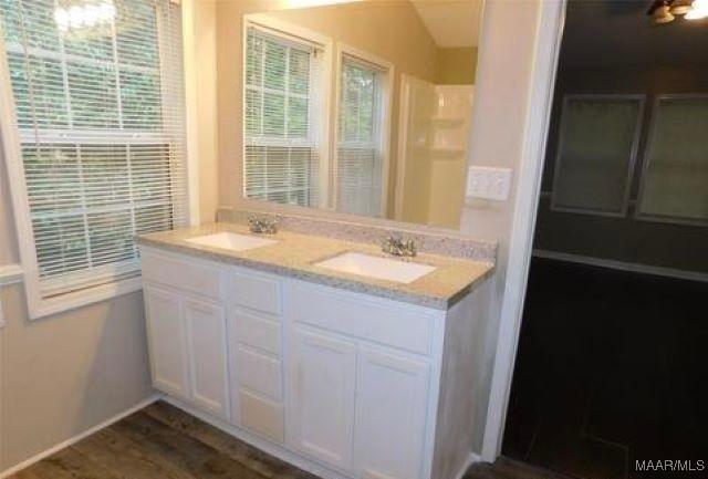 4097 Narrow Lane Rd, Montgomery, AL 36111 - full bathroom featuring double vanity and wood finished floors