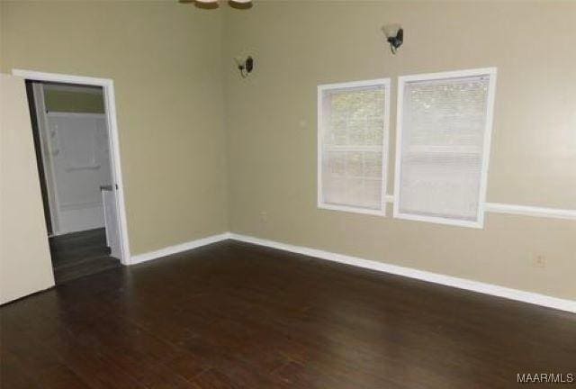 4097 Narrow Lane Rd, Montgomery, AL 36111 - empty room featuring dark wood-style floors and baseboards