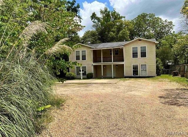 4097 Narrow Lane Rd, Montgomery, AL 36111 - back of property featuring a balcony, fence, and view of scattered trees