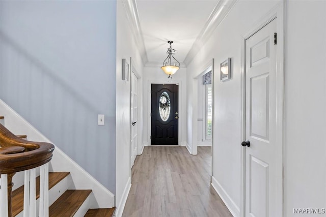 foyer with stairway, light wood-style flooring, and baseboards