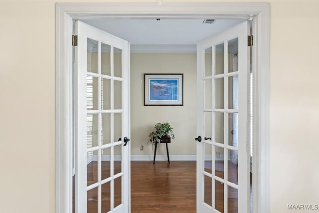 detailed view of french doors, wood finished floors, and baseboards