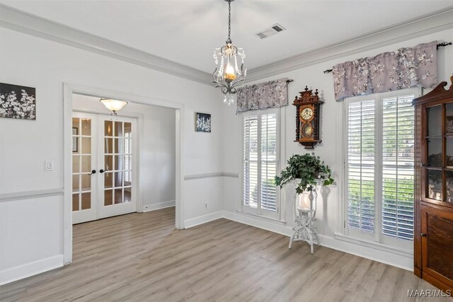 unfurnished dining area with wood finished floors, french doors, and baseboards