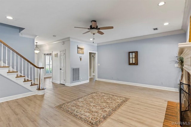 entryway with a ceiling fan, crown molding, wood finished floors, recessed lighting, and stairway