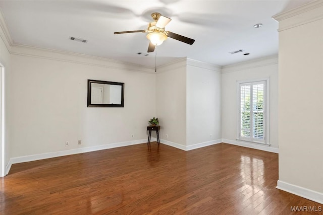 spare room featuring wood finished floors, a ceiling fan, ornamental molding, baseboards, and a pendent fire sprinkler