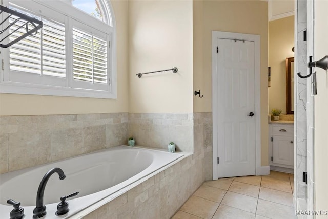 full bathroom featuring tile patterned floors, a garden tub, and vanity