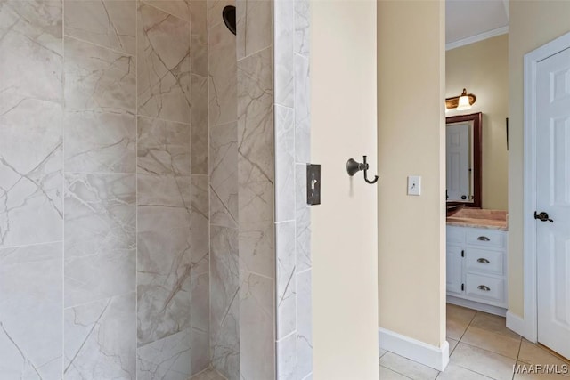 full bath featuring ornamental molding, a tile shower, vanity, and tile patterned floors