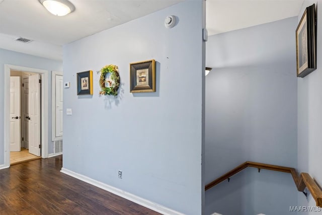 hall with wood finished floors and baseboards