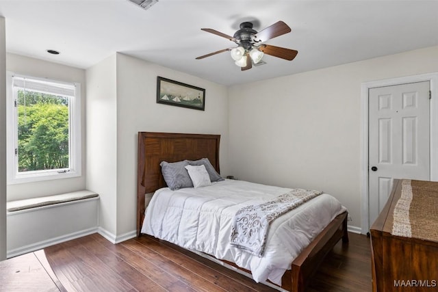 bedroom with wood finished floors, baseboards, and ceiling fan
