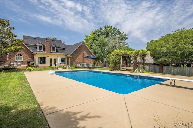 view of pool featuring a patio area and a diving board
