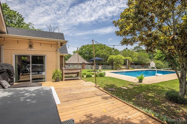 outdoor pool with a deck and a grill