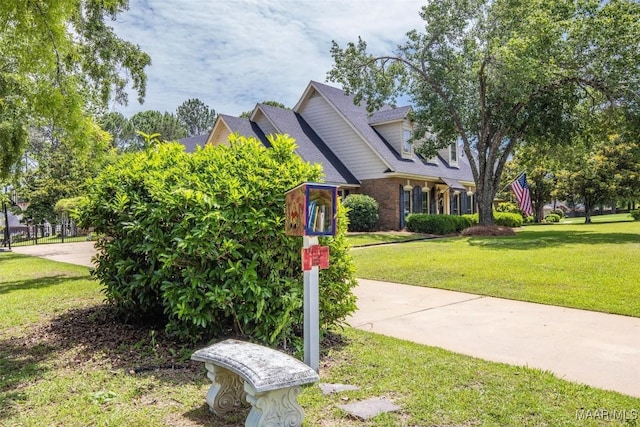 view of front facade with a front lawn and brick siding