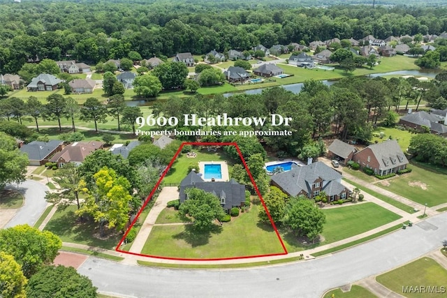 aerial perspective of suburban area with a nearby body of water and property parcel outlined