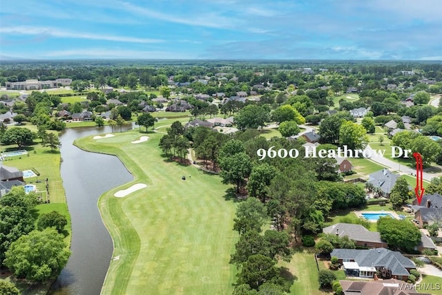 aerial view of residential area featuring a large body of water and a golf course