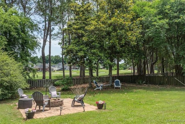 view of yard featuring a fire pit and a patio