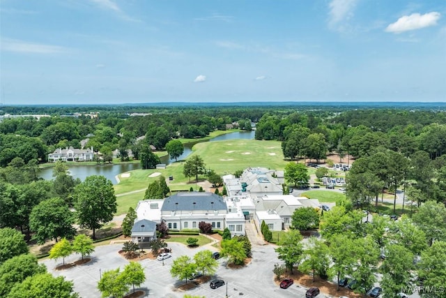 bird's eye view of a nearby body of water, a local golf course, and a tree filled landscape