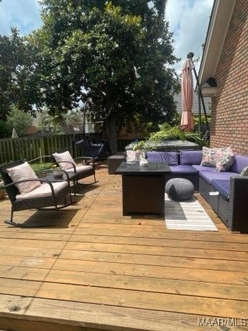 wooden deck featuring an outdoor hangout area