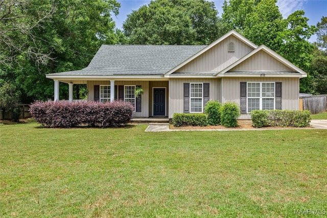 ranch-style house with a shingled roof and a porch