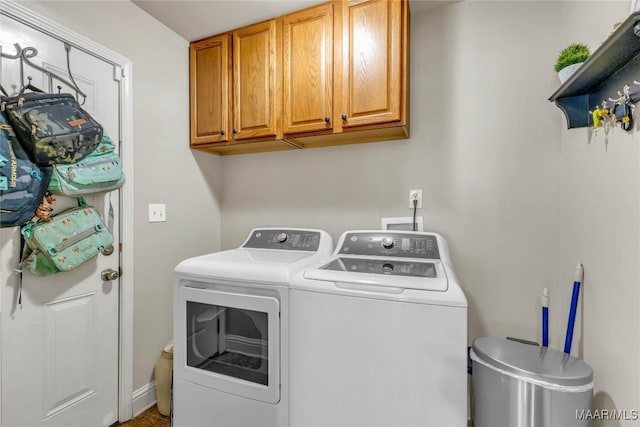 washroom featuring washer and dryer and cabinet space