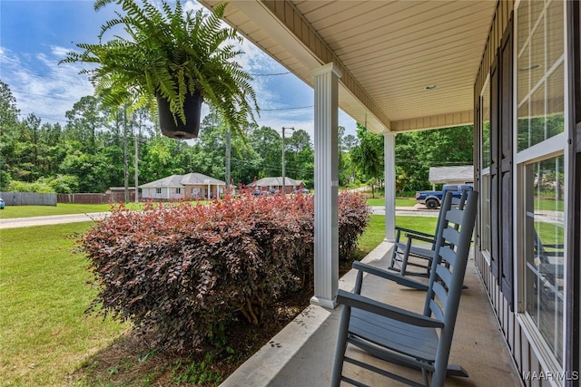 view of patio with covered porch and view of scattered trees
