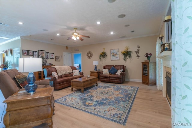 705 Yellowstone Dr, Prattville, AL 36067 - living area featuring a ceiling fan, recessed lighting, light wood finished floors, a fireplace, and ornamental molding