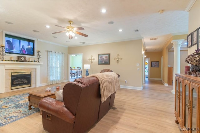 705 Yellowstone Dr, Prattville, AL 36067 - living area featuring ceiling fan, light wood finished floors, a tile fireplace, baseboards, and ornamental molding