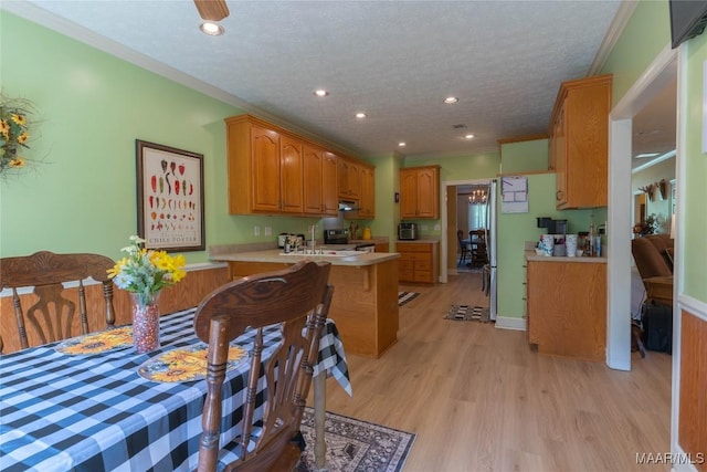 705 Yellowstone Dr, Prattville, AL 36067 - kitchen with stainless steel electric range oven, ornamental molding, light countertops, a peninsula, and light wood-style flooring
