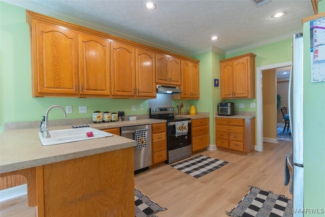 705 Yellowstone Dr, Prattville, AL 36067 - kitchen featuring stainless steel appliances, under cabinet range hood, a sink, a peninsula, and light countertops