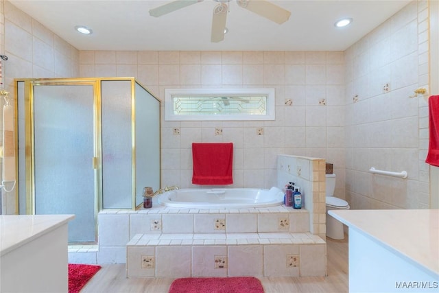 705 Yellowstone Dr, Prattville, AL 36067 - bathroom featuring a garden tub, a shower stall, a ceiling fan, wood finished floors, and vanity