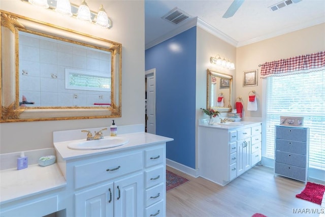 705 Yellowstone Dr, Prattville, AL 36067 - bathroom featuring wood finished floors, crown molding, two vanities, baseboards, and ceiling fan