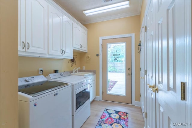 705 Yellowstone Dr, Prattville, AL 36067 - washroom featuring cabinet space, washing machine and clothes dryer, crown molding, light wood-style floors, and baseboards