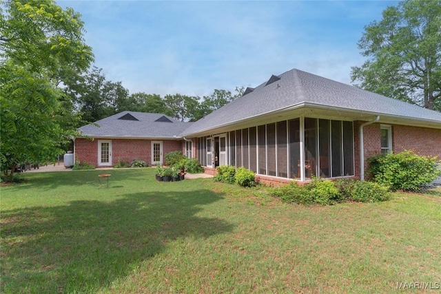 705 Yellowstone Dr, Prattville, AL 36067 - rear view of house featuring a yard, brick siding, and a sunroom