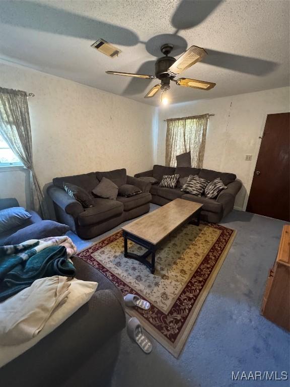 carpeted living room featuring a ceiling fan