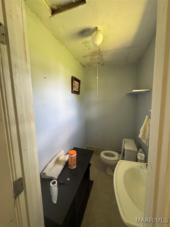 bathroom featuring toilet and tile patterned floors