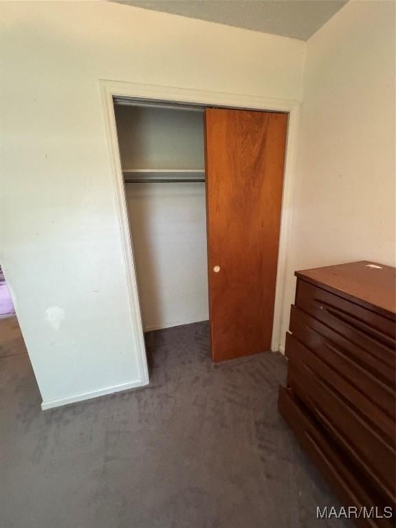 unfurnished bedroom with a closet and carpet