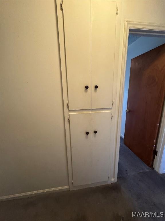 detailed view of carpet flooring and baseboards