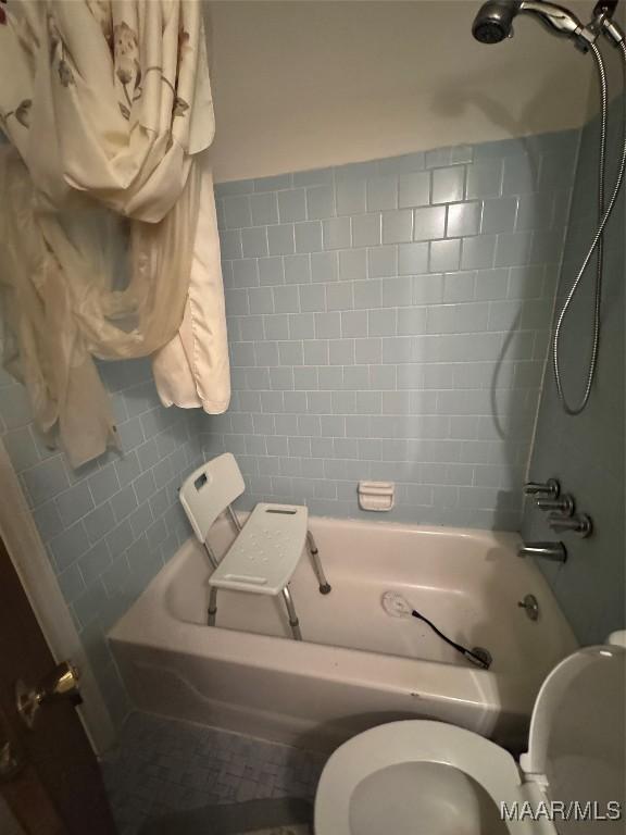 bathroom featuring toilet and shower / bath combination