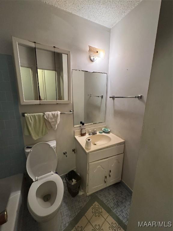 bathroom featuring a textured ceiling and vanity