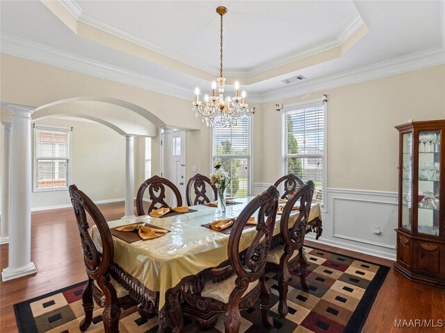 6812 Overview Ct, Montgomery, AL 36117 - dining space with decorative columns, a tray ceiling, arched walkways, plenty of natural light, and ornamental molding