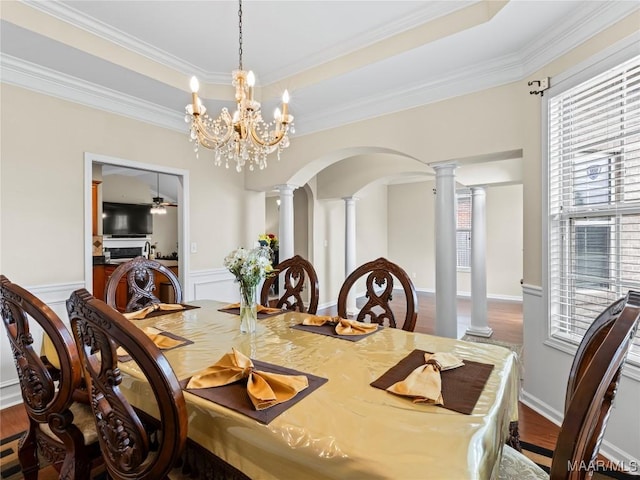 6812 Overview Ct, Montgomery, AL 36117 - dining space featuring decorative columns, ornamental molding, arched walkways, a chandelier, and wood finished floors